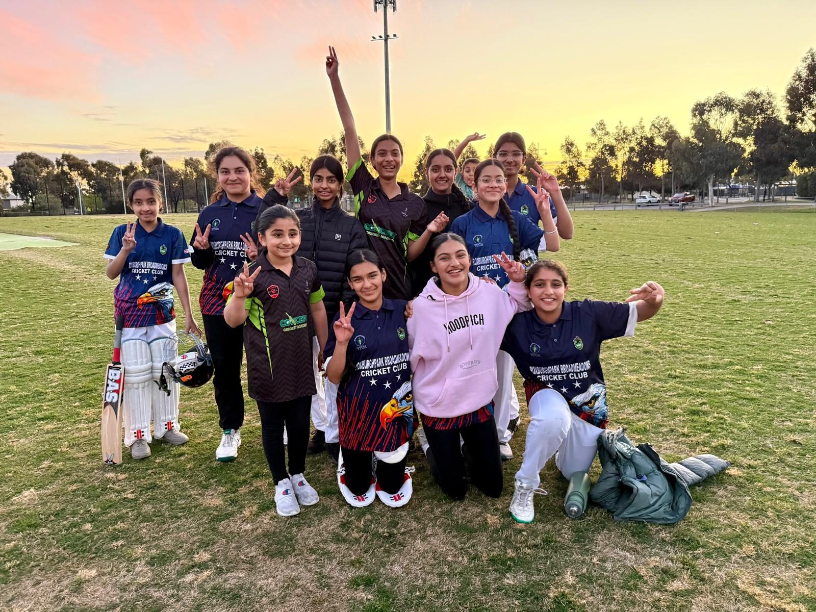 Girls cricket under a Roxburgh Park sunset